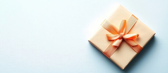 Elegant gift box with orange ribbon on light background for spa or cosmetics treatment certificate display with space for personalized message