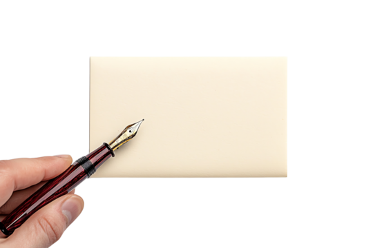 A hand holds a fountain pen above a blank notecard on a black background, suggesting preparation for writing or correspondence.