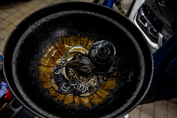Close up used motor oil filter and oil during repairing vehicle at the car service