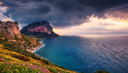 Fototapeta premium Aerial view at sunset over the Mediterranean sea. Location place Island Sicilia, Zafferano cape, Palermo city, Italy, Europe. Scenic image of famous european resort. Discover the beauty of earth.