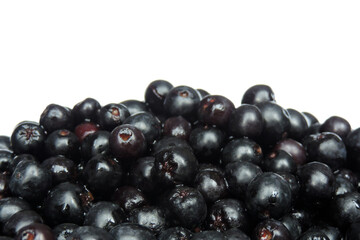 A pile of fresh aronia berries decorated, white background