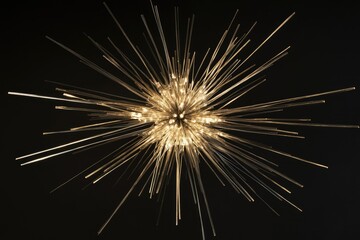Obraz premium A radiant, starburst-shaped light fixture with numerous slender, illuminated rays against a dark background.