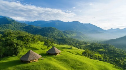 Serene Landscape with Traditional Thatched Roof Huts Set Against Lush Green Hills and Majestic Mountain Range Under a Blue Sky with Soft Clouds