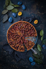 Traditional German zwetschgenkuchen with sliced plums served as close-up on a Nordic design plate...