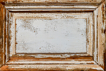 Aged wooden panel with white cracked paint, exposing the natural wood beneath