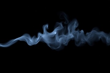 Fototapeta premium smoke is rising from a cigarette in the dark