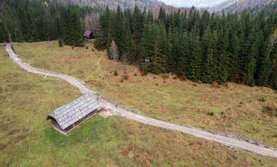 Drone aerial of wooden mountain hut overlooking valley julian alps, slovenia.