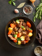 Beef stew with potatoes, carrots and greens
