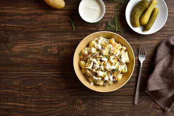 Warm potato salad with egg, pickle, red onion with mayonnaise an
