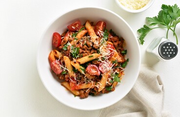 Bowl of bolognese penne pasta with minced meat, tomatoes