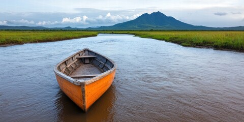 Fototapeta premium A serene landscape with an orange boat and a mountain backdrop.