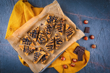 Homemade sheet pan hazelnuts cookie bar chips with roasted chopped hazelnuts chocolate glaze...