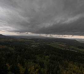 Autumn rainy sky over mountains, autumn mountains from above. Drone view. Poland, Table Mountains.