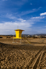 Scenic view of an iconic yellow lifeguard tower on tropical sand dune beach, Canary Islands