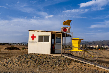 Scenic view of an iconic yellow lifeguard tower with yellow flag on tropical sand dune beach, Canary Islands