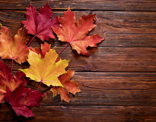 Obraz premium Autumn Maple Leaves on Rustic Brown Wooden Background, Generated image