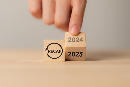 2024 Recap economy, business, financial concept. Business planning in 2025. RECAP text on wooden blocks and hand flipping of 2024 to 2025 on wooden blocks on minimal grey background and copy space.