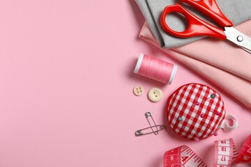 Flat lay composition with various sewing accessories on color backgroud