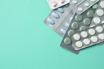 Various blisters with tablets on a colored background