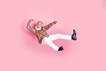 Photo of funky cheerful grandfather wear trendy print clothes have fun fly air isolated on pink color background
