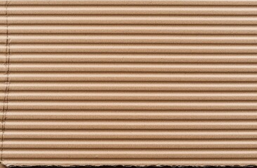 Obraz premium The texture of a brown cardboard sheet creates an abstract background, featuring the old vintage pattern of a recycled paper box, perfect for design art projects.