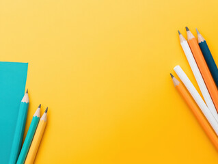 Colorful pencils on vibrant yellow background create cheerful scene