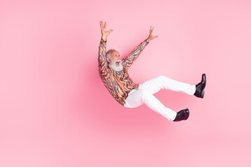 Photo of funky crazy senior man wear trendy print clothes fly air fall down empty space isolated on...