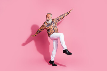 Photo of excited old man feel young playing dancing flying plane wear glamour clothes isolated pink color background