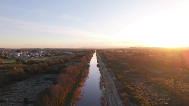Grand Canal During Golden Sunset In County Kildare, Ireland. - aerial shot