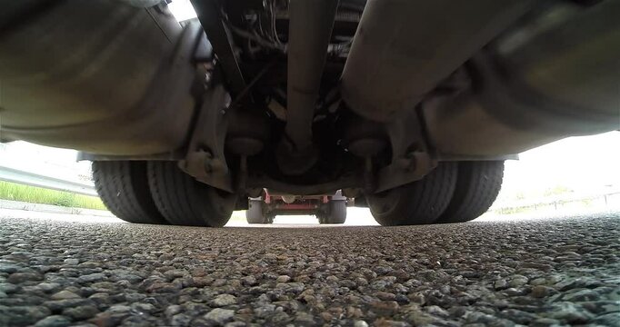 A truck passes over the camera. A big truck is driving on the highway. Concept of transportation logistics. 