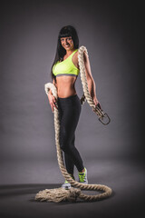 Athletic Woman Posing with Heavy Training Rope