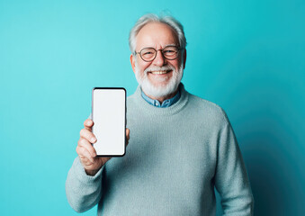Happy Senior Man Holding a Smartphone With a Blank Screen Against a Bright Blue Background, Phone Mockup