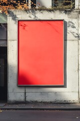 A mock-up of an advertisment display board with a red frame and dark gray background, set on the side of an office building