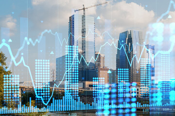 A cityscape with digital hologram charts overlaid, presenting a concept of future technology and business analytics against an urban background. Double exposure