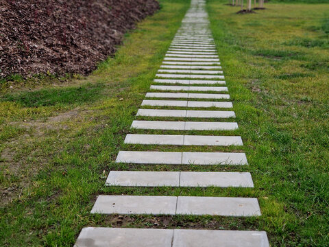 concrete path lawn pedal rectangular shape in regular grid routed directly through beautiful lawn suns and shadows stone , concrete large slabs, slab, rectangle, railroad tie