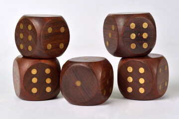 A group of five large wooden gaming dice on a white background