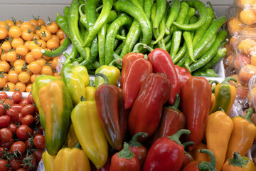 Vegetable counter. Bell peppers, cherry tomatoes close-up.
