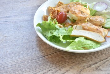 fresh vegetable topping boiled egg topping crispy fried taro dressing Indian sauce salad on plate 