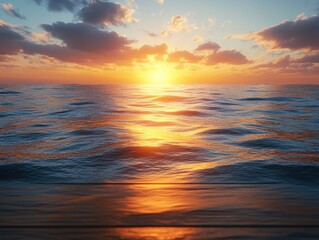 Obraz premium Warm orange and yellow rays illuminate the ocean waves as the sun sets on the horizon, creating a peaceful atmosphere