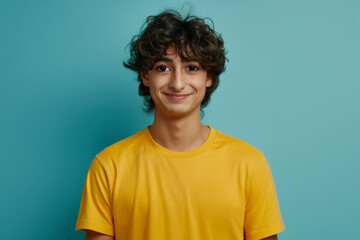 Portrait of handsome teenager with a smiling face in a green background