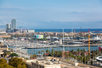 Obraz premium Modern buildings rising on barcelona's waterfront, featuring the iconic cable car tower