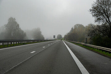 Driving by car on road in Belgium, fog in Ardennes ,nature park, Wallonia