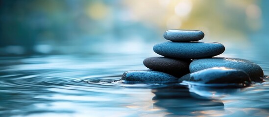 Calm water flowing over smooth stones creating a tranquil natural scenery with reflections and soft bokeh background elements