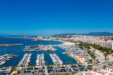 Blanes cityscape with harbor, beach and sa palomera rock in summertime
