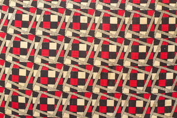Textura con cuadros y rombos de color rojo, negro y beige. Vista superior y de cerca