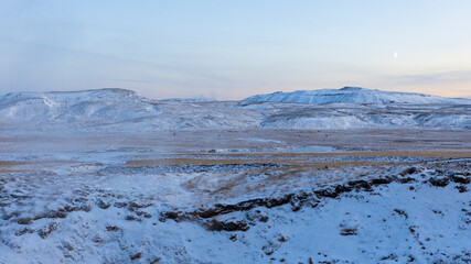 Winter landscape with steam coming out of the ground due to volcanic activity. Geothermal area Seltun at Reykjanes peninsula in ICeland.