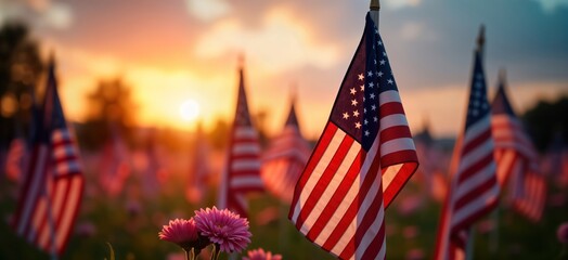 Memorial Day tribute scene at sunset. Many American flags gently wave in soft evening light. Pink flowers blossom in front of flags. Moment of remembrance, gratitude for courageous heroes. Solemn