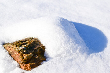 Natural stone plinth sunlight shadow texture white snow background in winter for product display