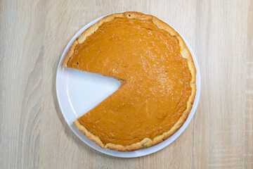 Pumpkin pie with caramel sauce on the white background. Traditional cake. Ready to eat. Cooking concept. Halloween time