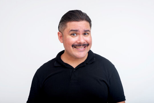 A socially inept and meek middle-aged man making an awkward smile. Isolated on a white background.